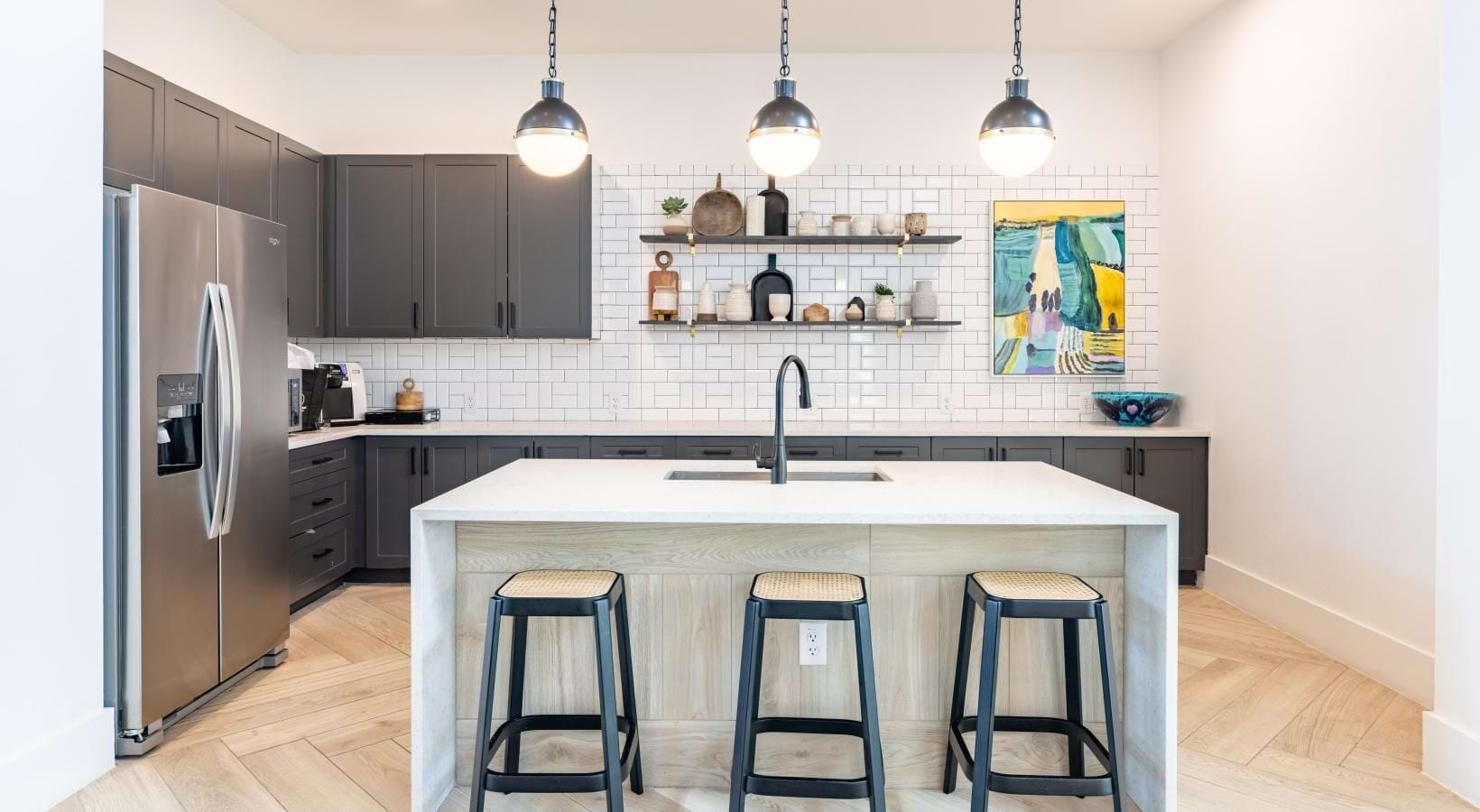 a kitchen with a bar stool and a white counter top
