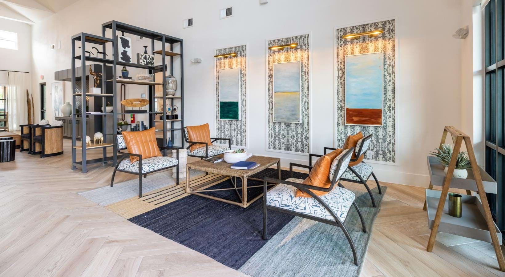 a clubroom with a coffee table and chairs