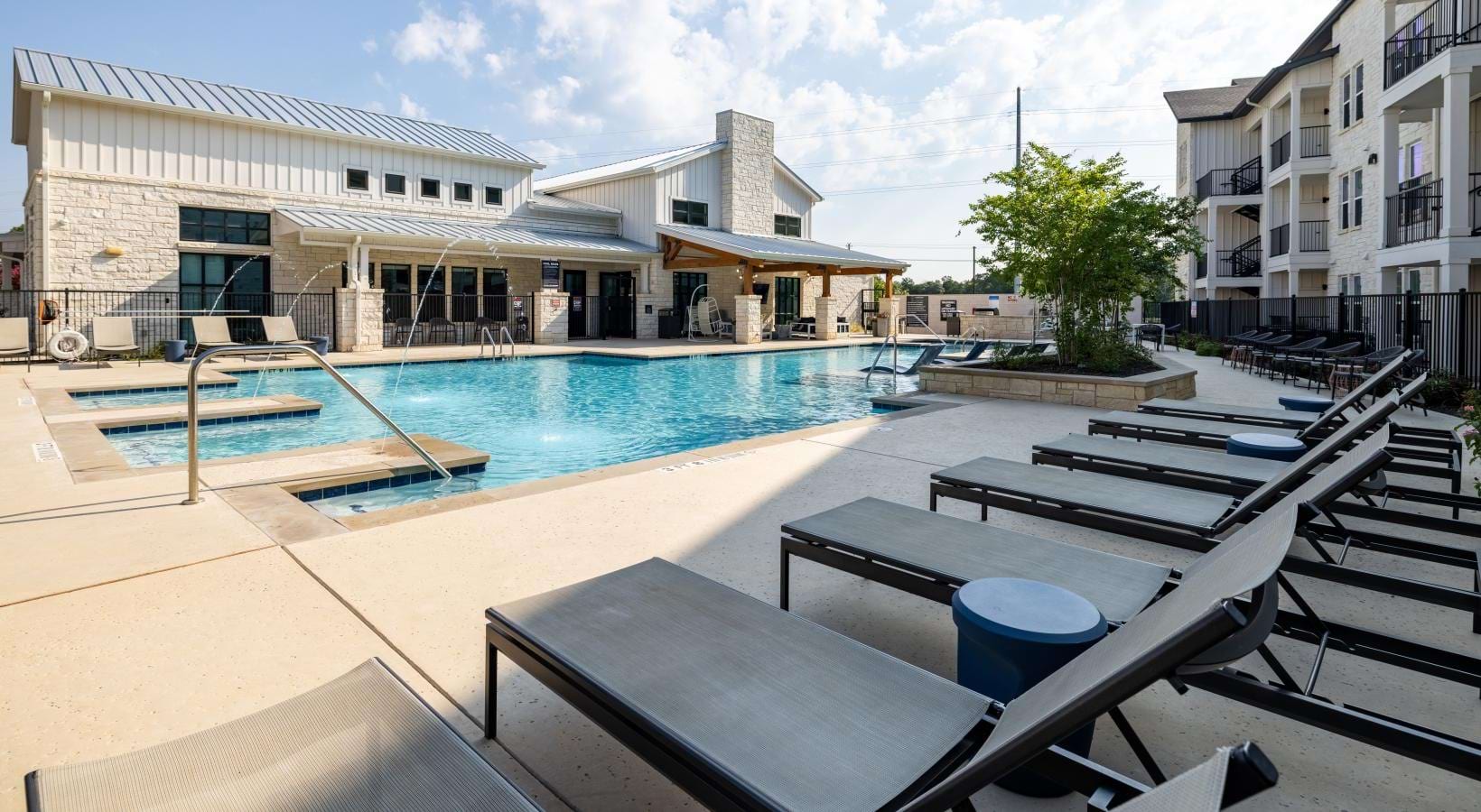 a swimming pool with lounge chairs