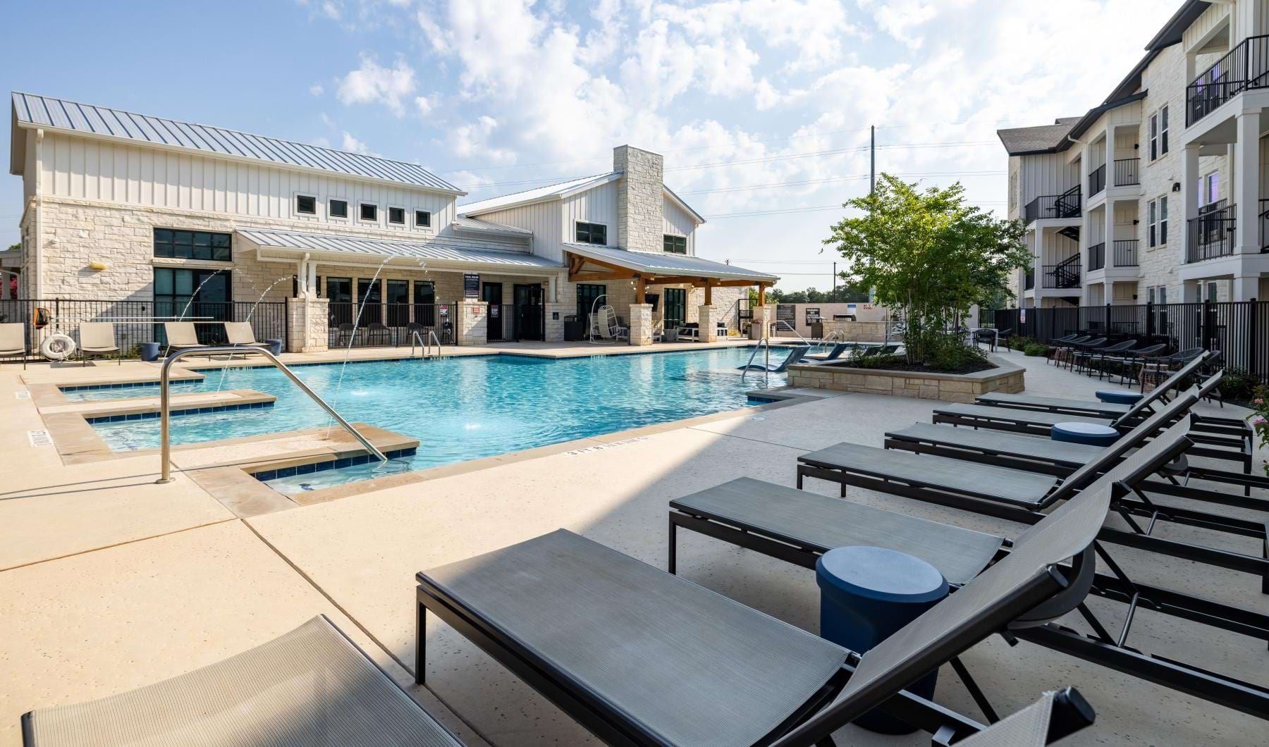 a swimming pool with lounge chairs