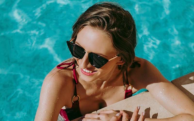 Woman relaxing in a sparkling blue pool