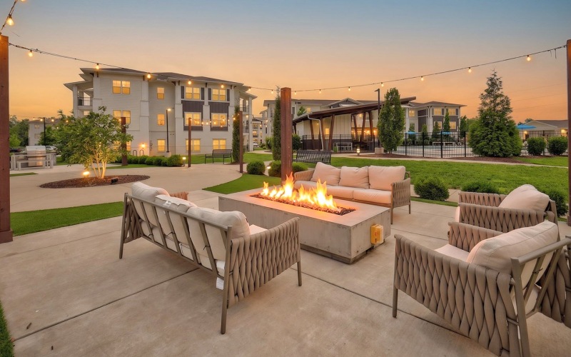 evening view of firepit lounge with couch and chairs