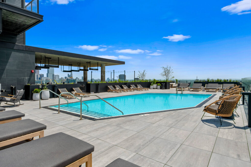 expansive sundeck with lounge chairs around the swimming pool on the rooftop of Parq Fulton