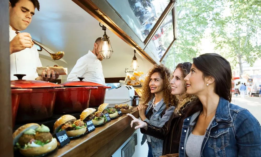 three ladies ordering from food truck