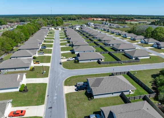 an aerial view of a row of houses in a parking lot