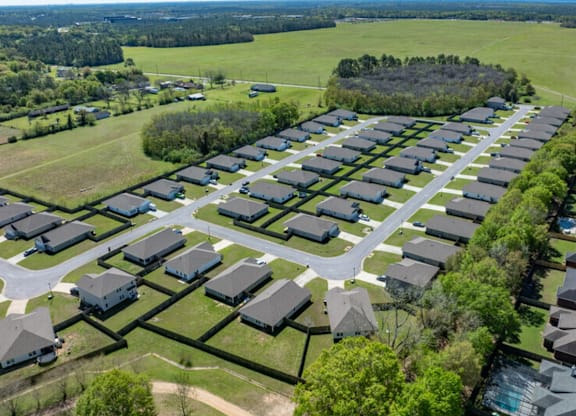 an aerial view of a neighborhood with many houses and trees