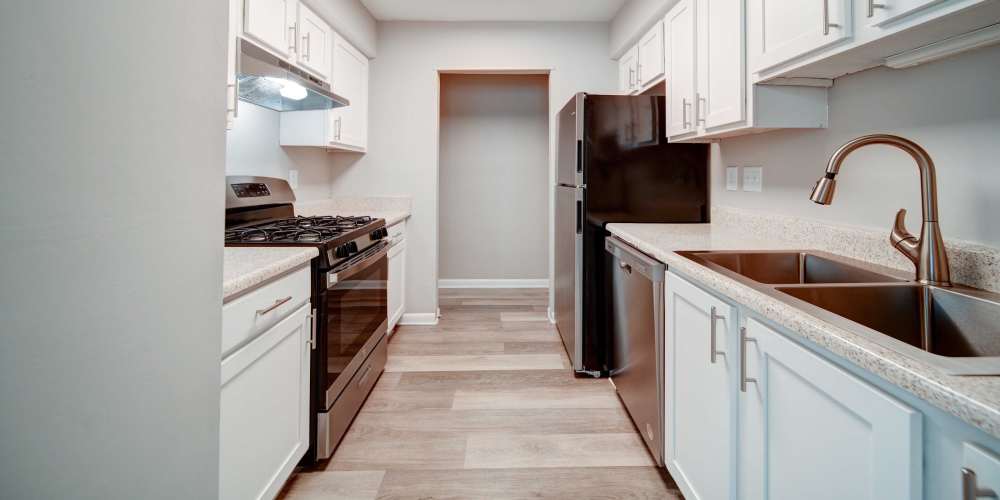 Kitchen with stainless-steel appliance at The George Apartment Homes in Savannah, Georgia