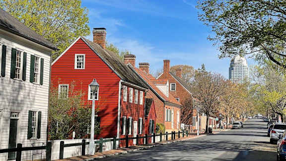 Historic Old Salem district in Winston-Salem NC near Sugar Creek Apartments featuring preserved colonial homes, walkable streets, and downtown skyline views.
