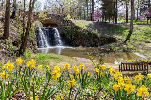 Waterfall and walking trail at Reynolda Gardens in Winston-Salem NC near Sugar Creek Apartments featuring scenic outdoor recreation close to Wake Forest University.