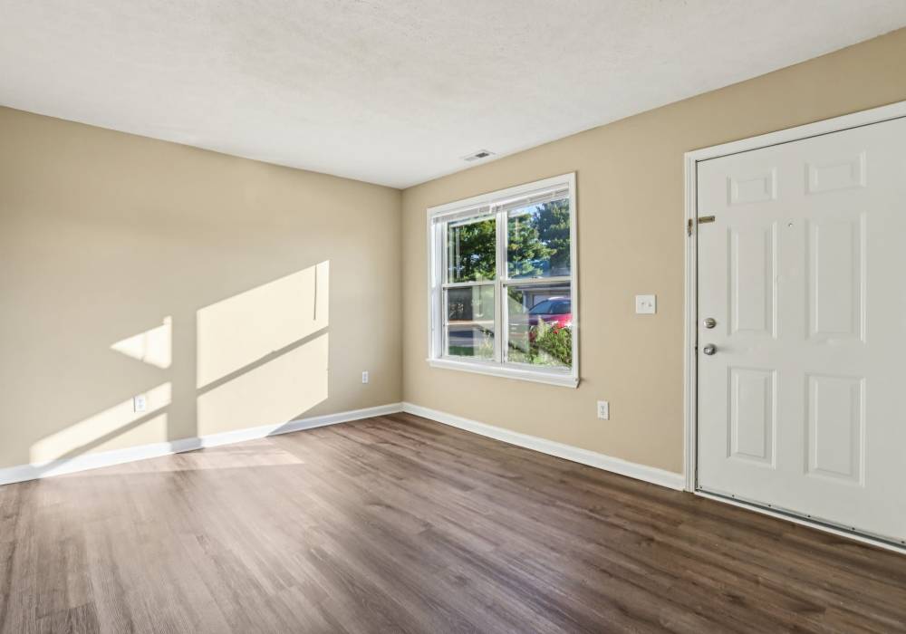 Living room with wooden flooring at Fox Pointe Apartments in Columbus, Indiana