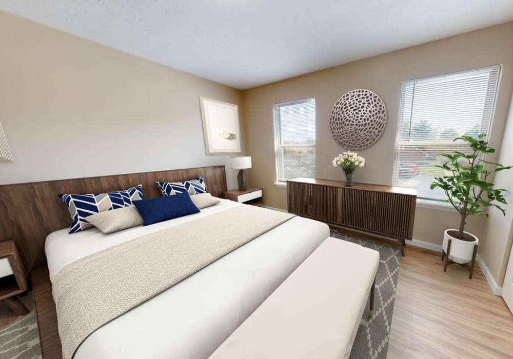 Bedroom with king size bed and large windows at Fox Pointe Apartments in Columbus, Indiana