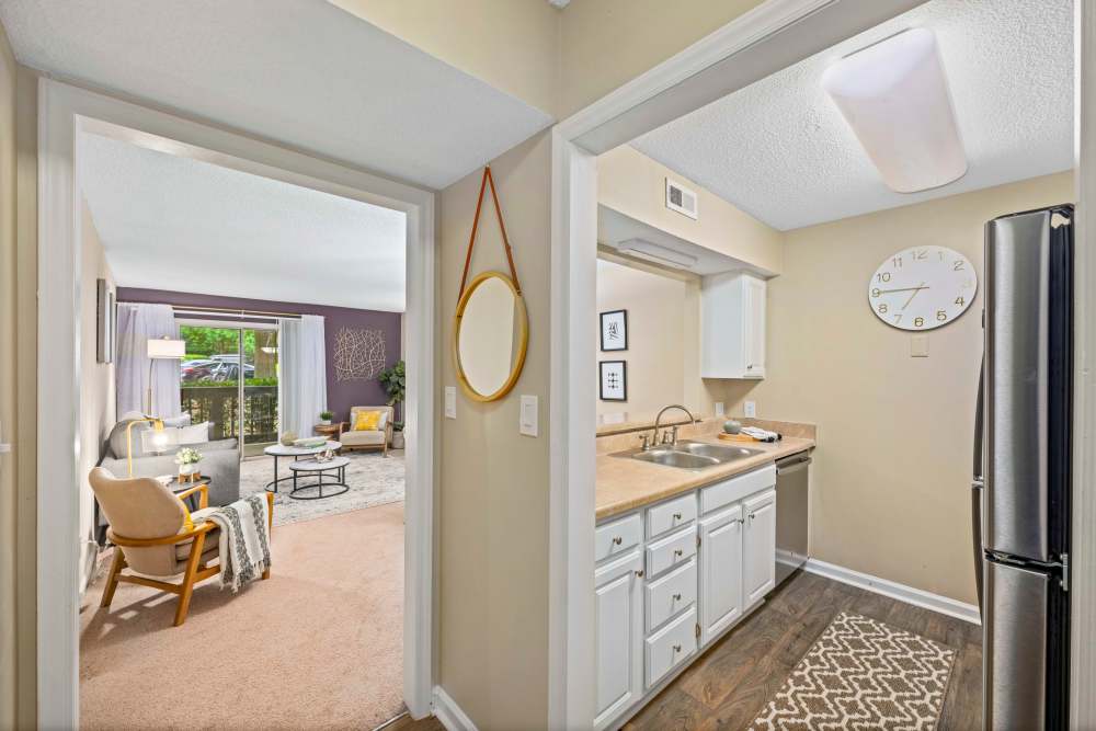 Kitchen connecting to living room in a model home at The Ellery of Cary in Cary, North Carolina