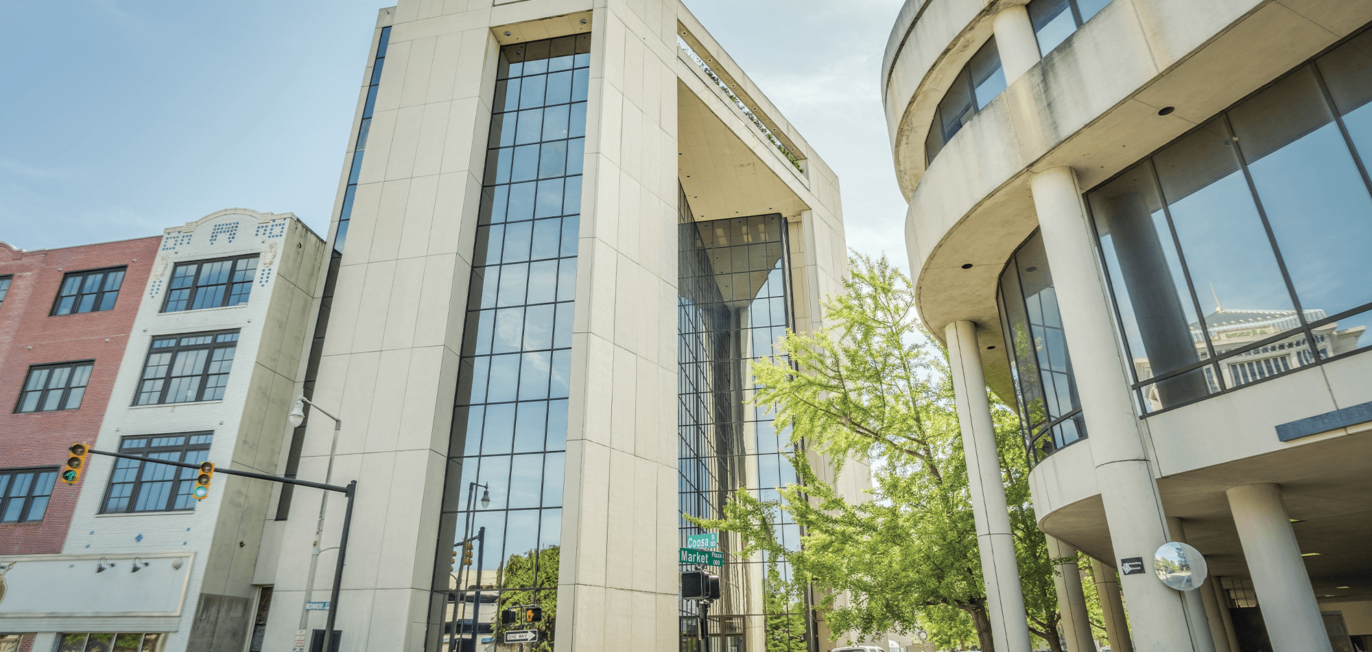 Exterior view of the 40 Four Building Complex in downtown Montgomery AL featuring white stone and large mirrored windows