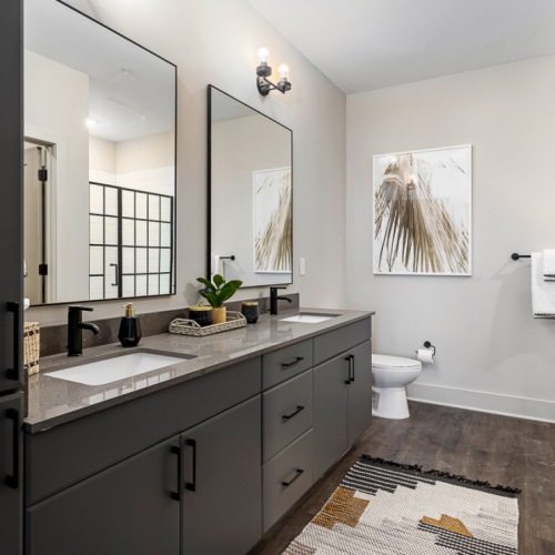 bathroom with double vanities and walk-in shower