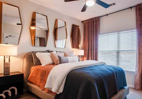 a bedroom with a bed and a ceiling fan