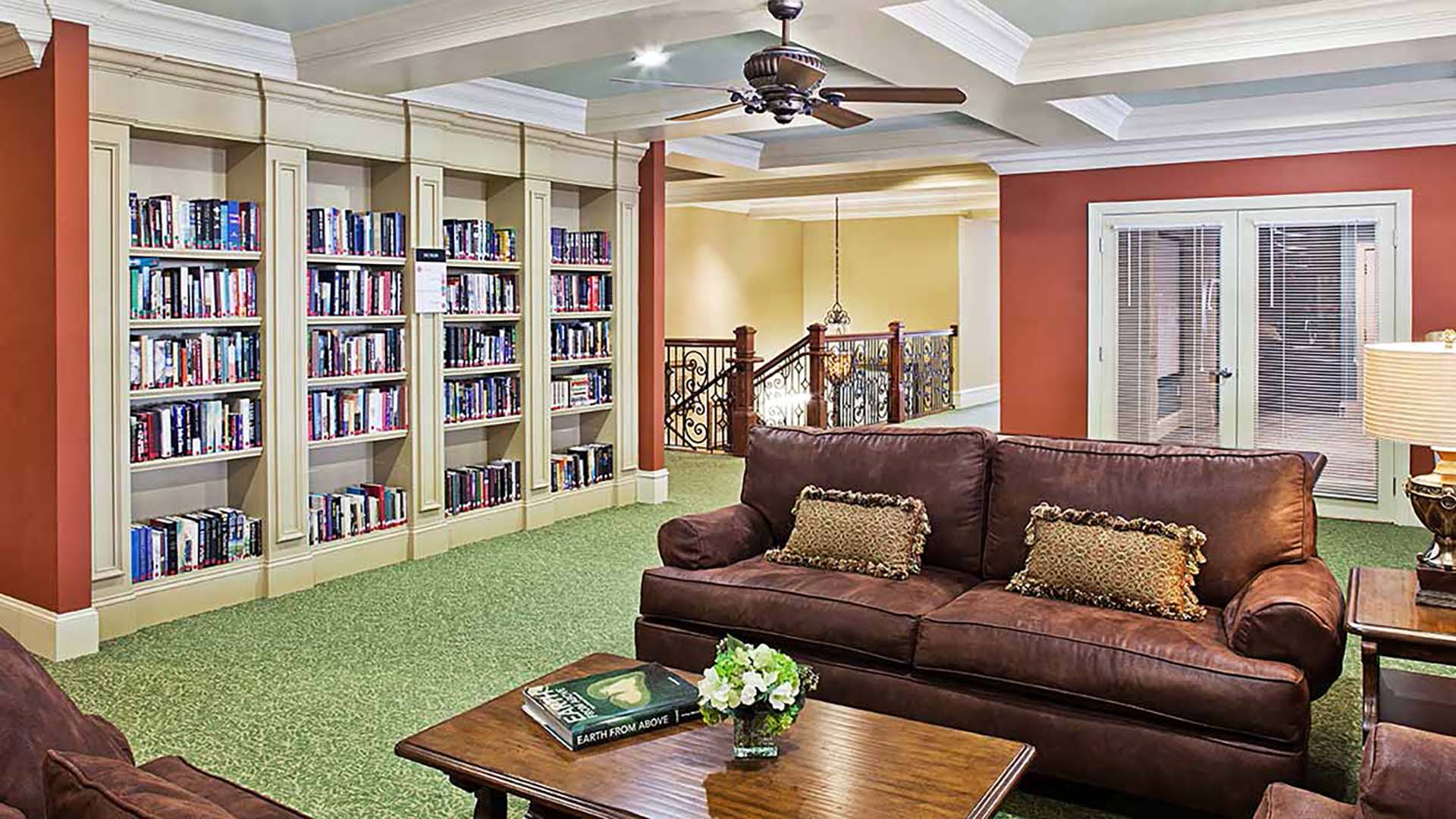 Library with a wide assortment of books, several couches, and chairs for reading