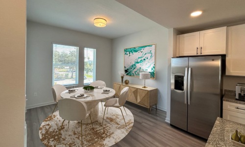 dining room with kitchen and windows