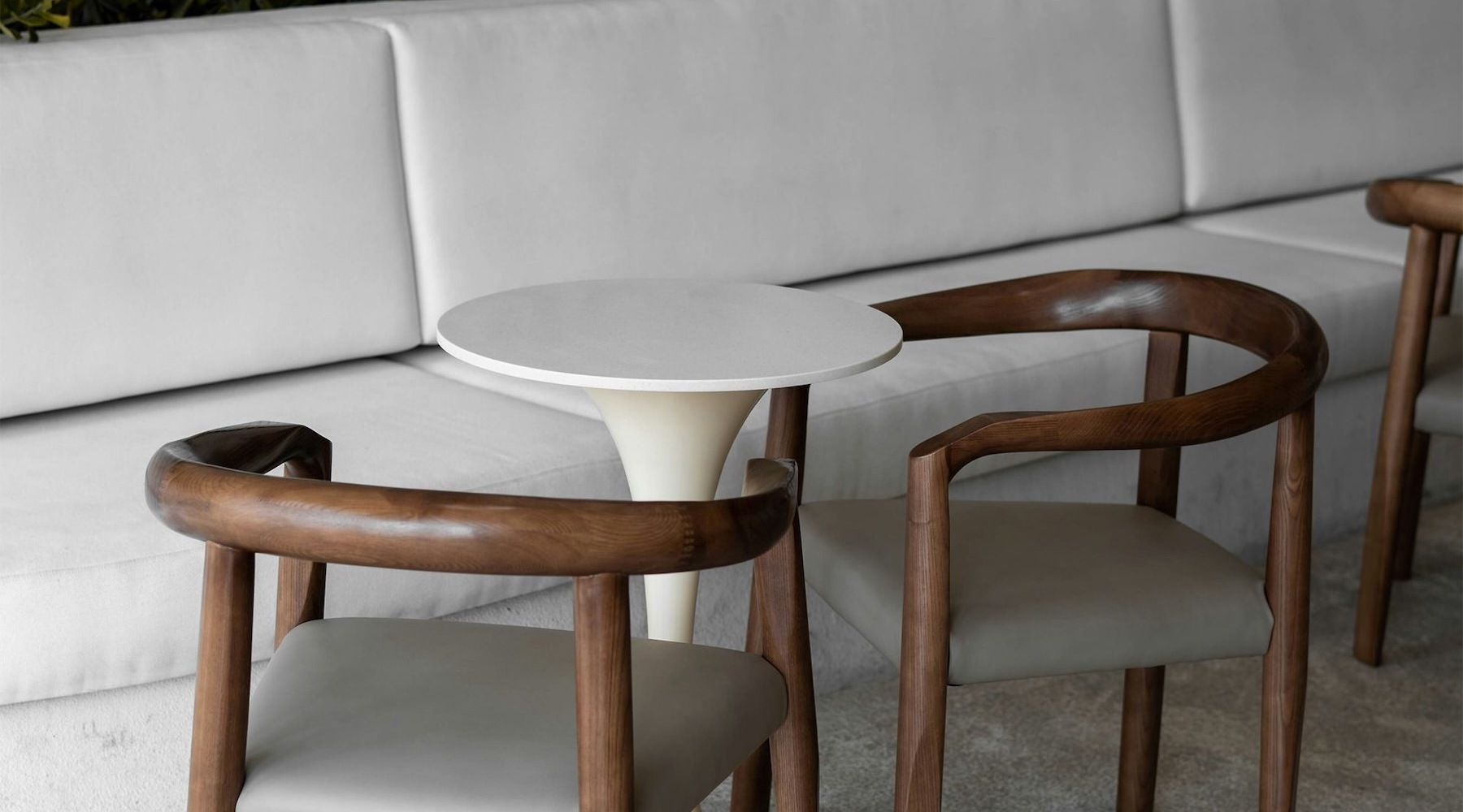 Two chairs with a bench and a table at Solstice at Eastland Yards apartments in Charlotte, NC.