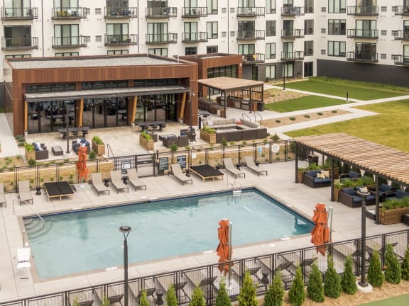 an aerial view of a swimming pool in front of an apartment building in shoreview, minnesota