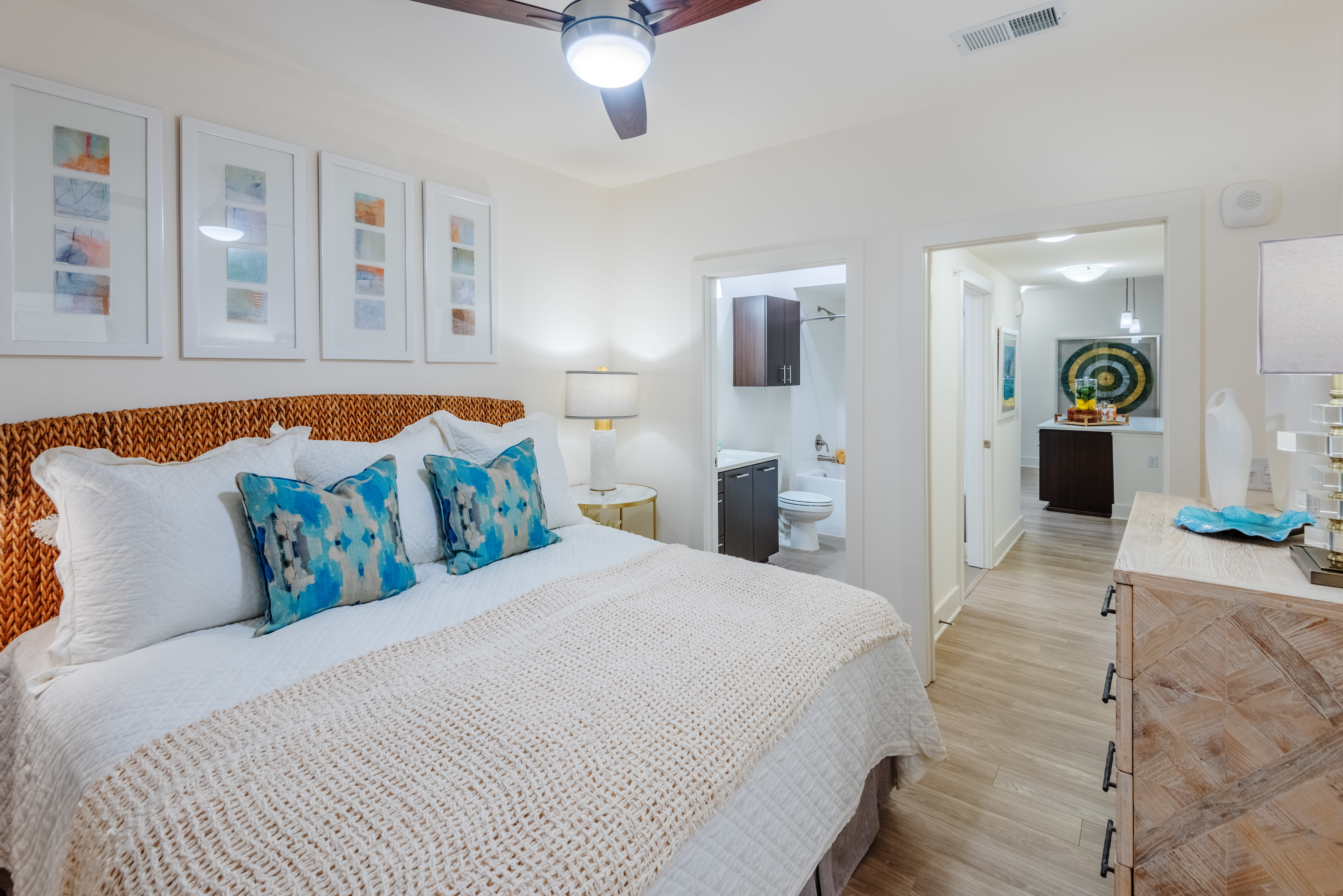 Model bedroom with wood-style flooring at The Reverie at Lake Boone in Raleigh, North Carolina