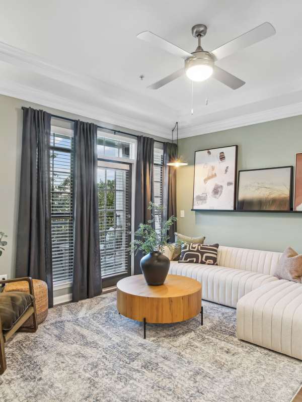 Spacious living area with large windows at Echo Ridge at Suwanee in Suwanee, Georgia