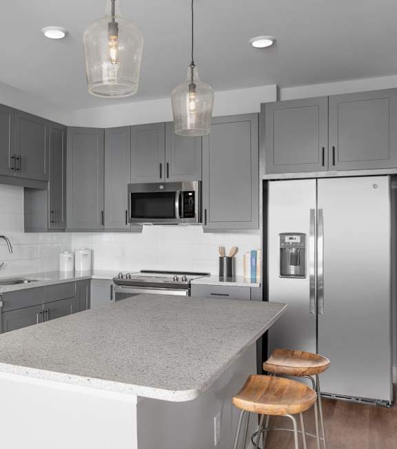 A modern kitchen with a large island in the middle.