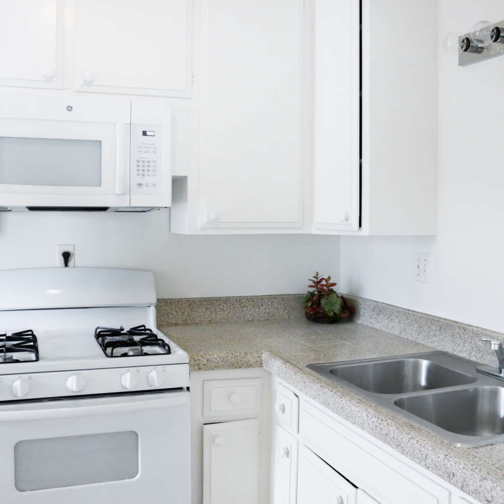 Kitchen with microwave and sink at Huntington Reef in Huntington Beach, California