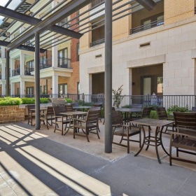 a patio with tables and chairs