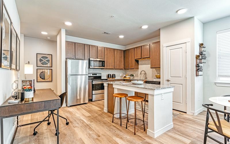 a kitchen with a bar stools