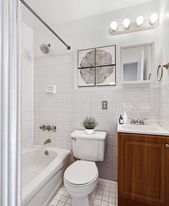 A white toilet sits next to a white sink in a bathroom.
