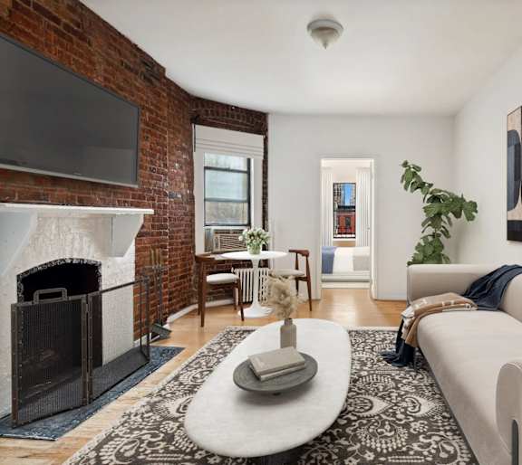 A living room with a fireplace and a television.