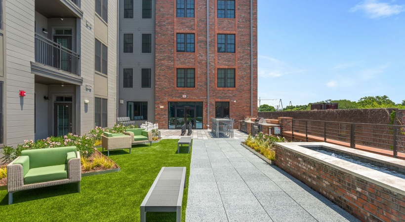 Outdoor seating and social area at The Porter apartments near Meeting Street in Charleston SC.