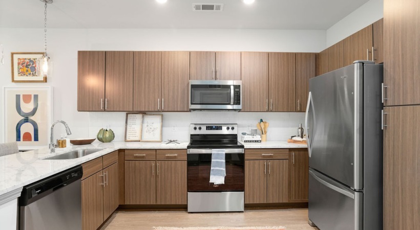 Contemporary kitchen with sleek cabinetry and stainless appliances at The Porter apartments in Charleston SC.