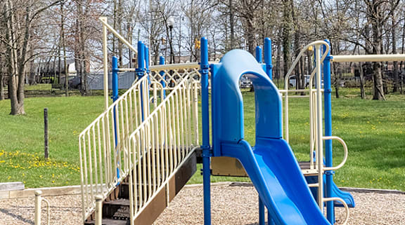 A playground with a blue slide and a wooden staircase at Dutch Village Apartments, Baltimore, MD, 21234