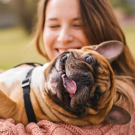 Women hugging a bulldog at Heritage on Hover Apartments, Longmont
