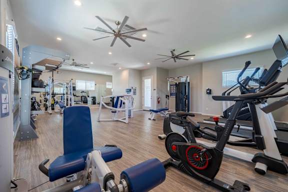 Modern fitness center with cardio and strength equipment at Vistoria On Mountain View Apartments, Surprise, 85374