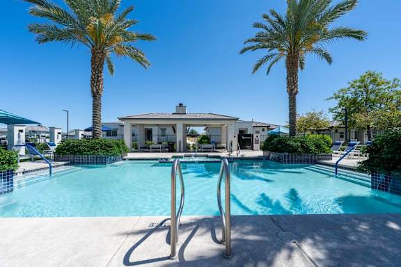 Swimming pool with pavilion and tropical landscaping at Vistoria On Mountain View Apartments, Surprise, AZ