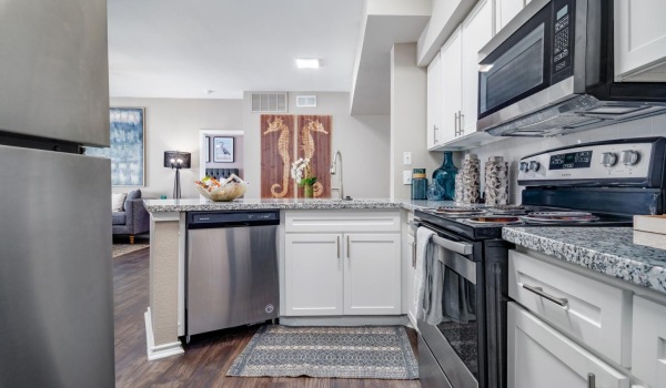kitchen with stainless steel appliances and white cabinets
