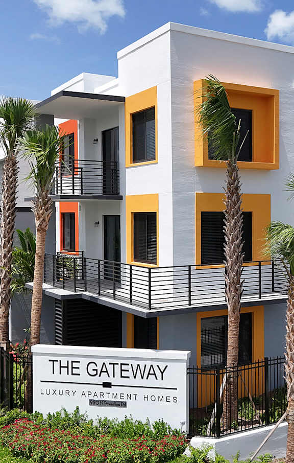 A white building with balconies and a sign that says "The Gateway".