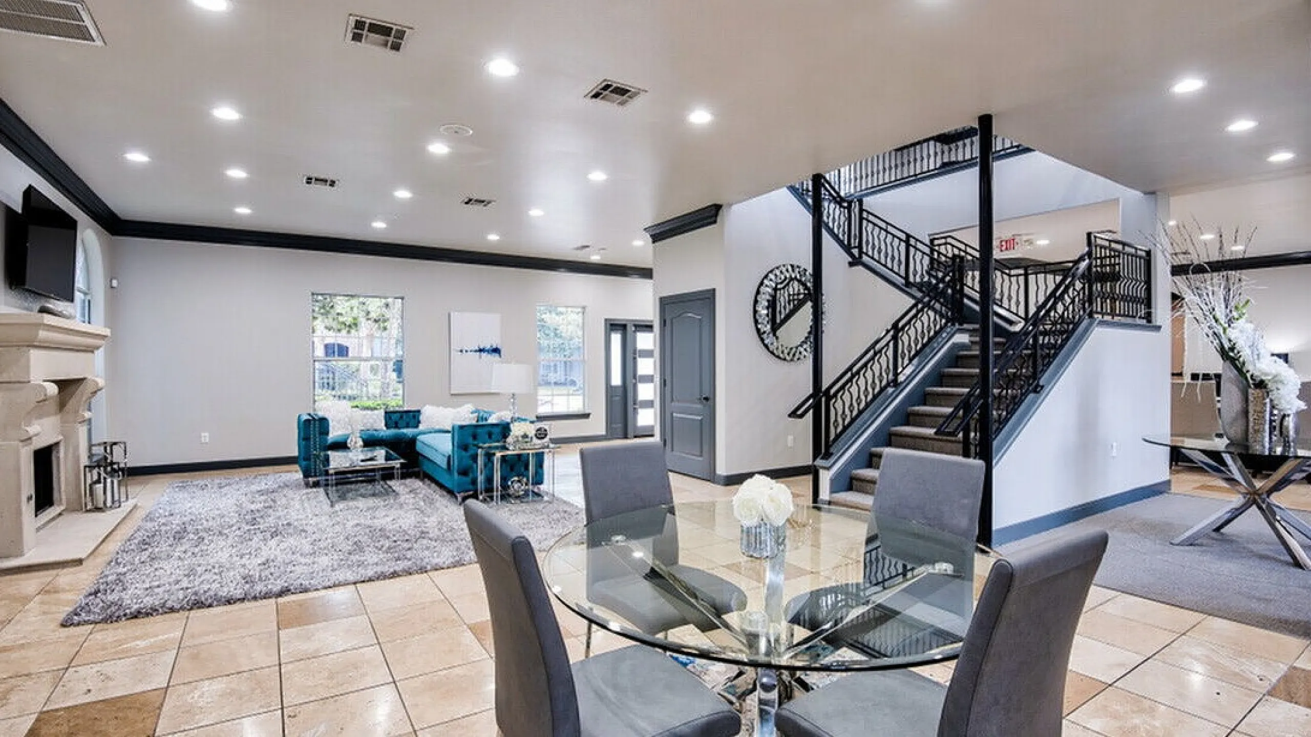 Luxurious modern living room showcasing elegant furniture, a stylish staircase, and abundant natural light, creating an inviting and spacious ambiance.