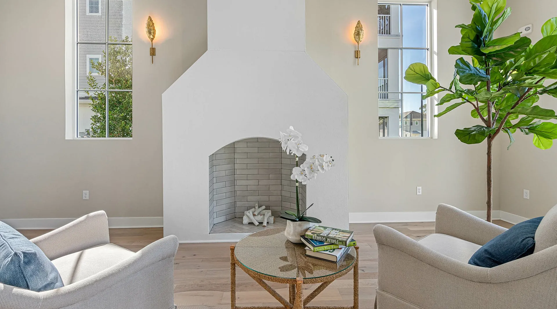 Bright and inviting living space with modern fireplace, cozy seating, and large windows offering natural light.