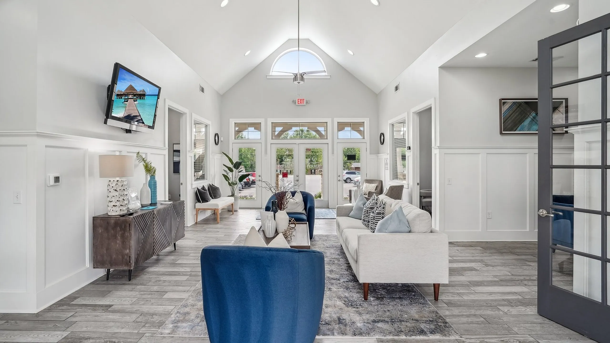 Luxurious living room featuring modern decor, vaulted ceilings, plush seating, and elegant natural lighting.