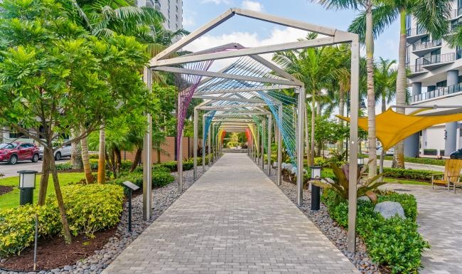 a walkway between palm trees