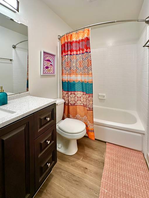 a bathroom with a toilet and a tub and a sink