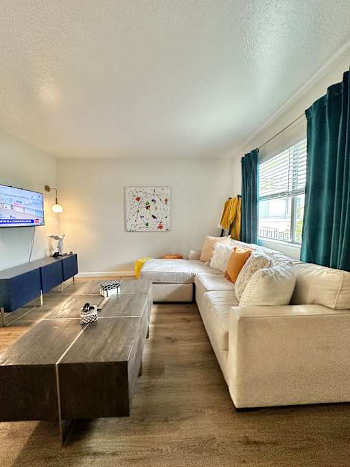 a living room with a couch and a coffee table and a tv