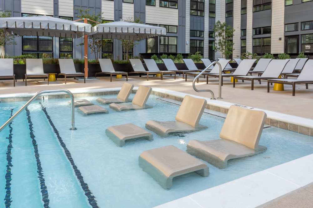 Saltwater pool with sun loungers at St. Albans Lofts in Raleigh, North Carolina
