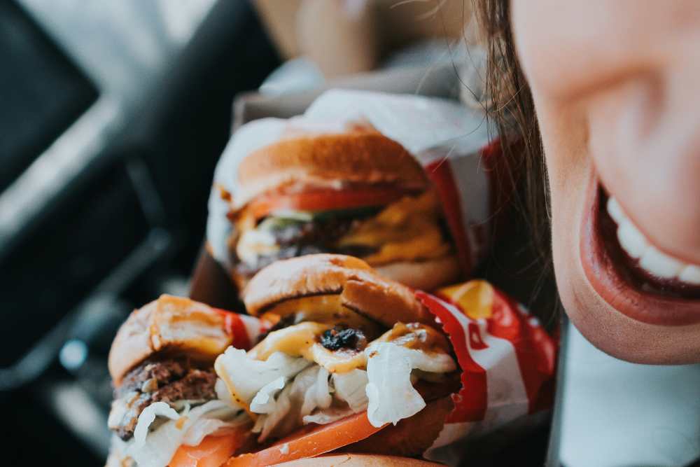Woman buying burgers near St. Albans Lofts in Raleigh, North Carolina