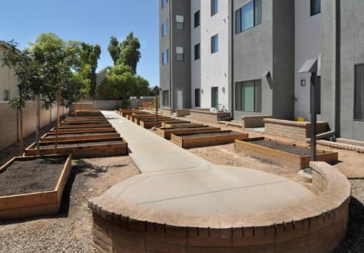 a row of benches in front of an apartment building