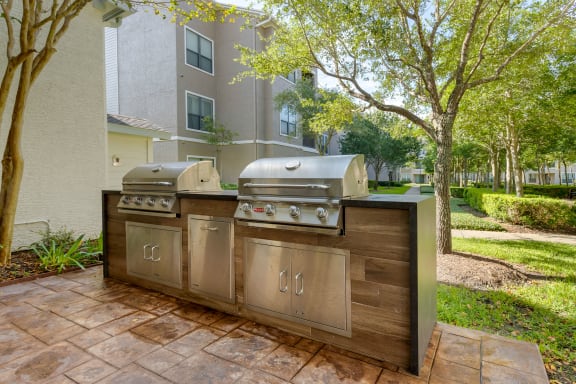 a stainless steel outdoor grill with two bbqs at Summerwind, Pearland