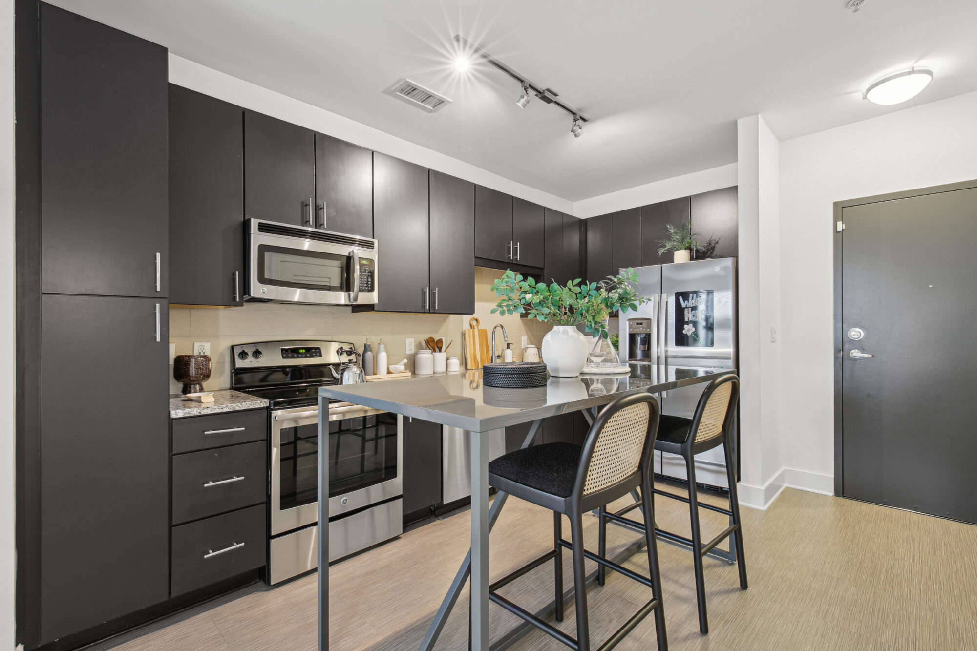 Kitchen with granite counters, stainless steel appliances, and island seating
